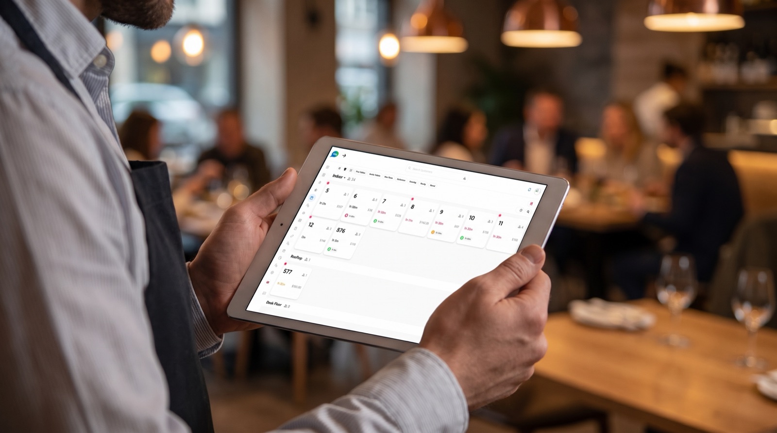 A waiter working the floor with Asky open on a tablet